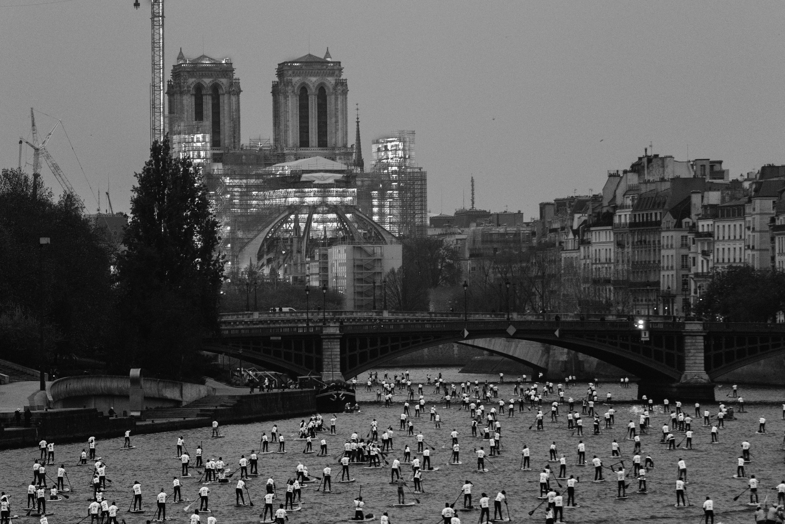20221204fra1010259.tif Hundreds of paddle boarders fill the Seine river in front of the Notre Dame cathedral of Paris in Dec. 2024. For special events, the Seine river can be closed to motorized traffic to allow paddle borders.